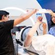 untrasound tech and UCSF staff installing an ultrasound machine with patient actor 