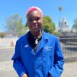 smiling black teen wearing a blue lab coat that reads UCSF Benioff Children's Hospital Oakland CHAMPS