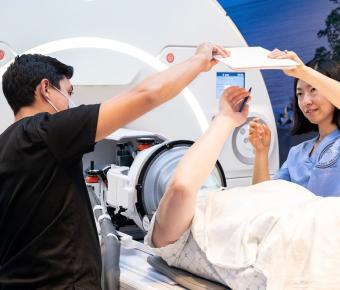 untrasound tech and UCSF staff installing an ultrasound machine with patient actor 
